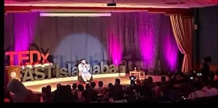 An Al-Burhan speaker addressing a full auditorium at FAST Islamabad